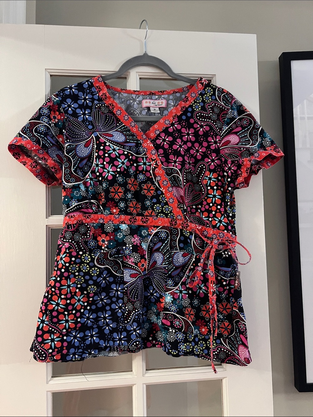 Koi Colorful Floral Wrap Scrub Top with Coral/Orange Trim